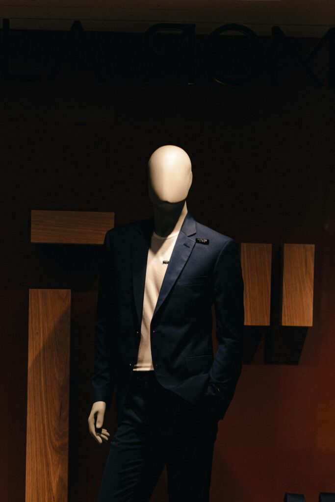 Stylish mannequin in a formal suit in low light, ideal for fashion and retail themes.